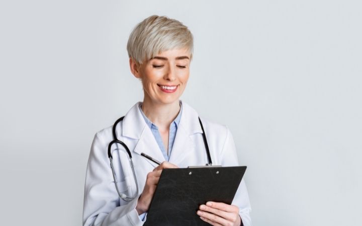 medical cannabis doctor processing information on a clipboard 